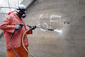 An employee removes graffiti